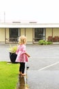 Photo of little girl standing under rain in Greymouth, New Zealand