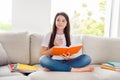 Photo of little pretty pupil school lady writing copybook diary composition homework sit sofa homey domestic social Royalty Free Stock Photo