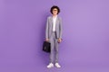 Photo of little schoolkid guy hold case stand posing wear spectacles grey suit isolated purple color background