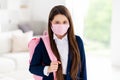 Photo of little student school girl student ready to go school hate epidemic rules facial masks irritated wear uniform