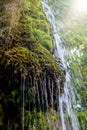 Photo of little waterfall flowing in cave