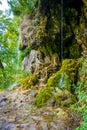 Photo of little waterfall flowing in cave