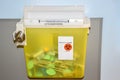 Photo of a locked yellow sharps container