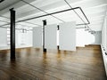 Photo of loft interior in modern building.Open space studio. Empty white canvas hanging.Wood floor, bricks wall