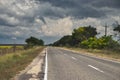 The photo of lonesome road and stormy clouds on the sky Royalty Free Stock Photo