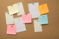 Photo of lot many colorful stickers and paper from copybooks attached to the wooden board with colorful pins Royalty Free Stock Photo