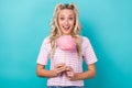 Photo of lovely astonished person hands hold cotton candy stick isolated on turquoise color background Royalty Free Stock Photo