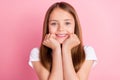 Photo of lovely blond little girl hands face wear white t-shirt isolated on pink color background Royalty Free Stock Photo