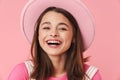 Photo of lovely charming girl in hat laughing and posing at camera