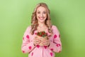 Photo of lovely cute person beaming smile arms hold fresh strawberry basket isolated on green color background Royalty Free Stock Photo