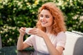 Photo of lovely dreamy pretty woman sitting in cafe drinking enjoying tasty cappuccino cafe summer terrace outside