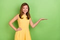 Photo of lovely kind teen girl advertisement product suggestion decision on green color background