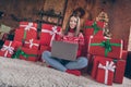 Photo of lovely lady sit boxes floor typing netbook congratulating email wear sweater in decorated x-mas home indoors