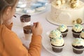 selective focus. Photo of lovely millennial child girl, thinks what to eat first Royalty Free Stock Photo