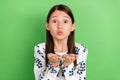 Photo of lovely pretty schoolkid girl hold hand send air kiss camera valentine day blogging over green color