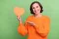 Photo of lovely senior woman show hand heart shape advertisings recommend isolated over green color background