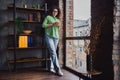 Photo of lovely successful woman drinking tasty coffee comfortable modern office loft room interior indoors workspace Royalty Free Stock Photo