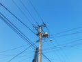Photo of a lower angle electric pole in the middle position with a blue sky