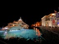 Photo of luxury yacht docked in picturesque port and main village of Hydra or Ydra island with beautiful neoclassic houses, Royalty Free Stock Photo