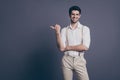 Photo of macho business man charming appearance indicating finger empty space dressed formalwear white shirt beige Royalty Free Stock Photo