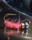 Macro shot of fly fishing lure on a black background, hand made fly for fishing Royalty Free Stock Photo