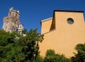 Photo made in Padua in Veneto (Italy) to the tower of the Observatory or the devil and aad a yellow building