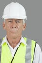 Portrait of male senior construction worker wearing hard hat over white background Royalty Free Stock Photo