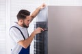 Technician Fixing Refrigerator Royalty Free Stock Photo