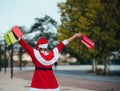 Photo of mama noel with skates holding a lantern with gift bags in hand. Christmas time Royalty Free Stock Photo