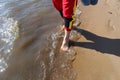 A man walks on the water along the shore with bare feet Royalty Free Stock Photo