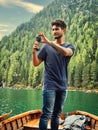 Photo of a man capturing the breathtaking beauty of the Dolomites from a boat in Italy
