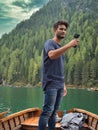 Photo of a man capturing the breathtaking beauty of the Dolomites from a boat in Italy