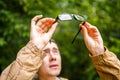 Photo of man holding glasses against trees