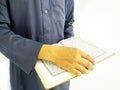 Photo of man holding a Koran ready for Ramadan.  Arabic on the cover is translated as the Qur`an Royalty Free Stock Photo