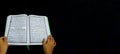 Photo of man holding a Koran ready for Ramadan.  Arabic on the cover is translated as the Qur`an Royalty Free Stock Photo