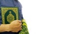 Photo of man holding a Koran ready for Ramadan.  Arabic on the cover is translated as the Qur`an Royalty Free Stock Photo