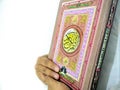 Photo of man holding a Koran ready for Ramadan.  Arabic on the cover is translated as the Qur`an Royalty Free Stock Photo