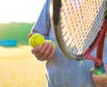 Man holding tenis racket and ball at court on sunny day