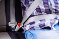 Photo of man in plaid shirt sitting in a car putting on seat belt Royalty Free Stock Photo