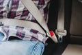 Photo of man in plaid shirt sitting in a car putting on seat belt Royalty Free Stock Photo