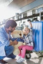 Portrait of man playing with his daughter while holding teddy bear in airport Royalty Free Stock Photo