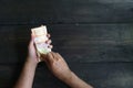 Photo of a man`s hand counting Indonesian five thousand rupiah in a bunch