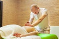 Photo of masseur performing traditional Thai massage on woman back in the spa salon. Beauty treatment concept Royalty Free Stock Photo