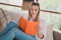 Photo of mature charming lady good mood look reading book science fiction apartment quarantine indoors