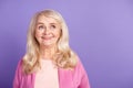 Photo of mature cheerful woman wonder look empty space idea clever cunning isolated over purple color background