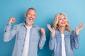 Photo of mature excited couple happy positive smile rejoice victory lucky success isolated over blue color background