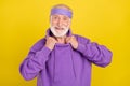 Photo of mature man good mood cool hands touch collar sporty outfit isolated over yellow color background Royalty Free Stock Photo