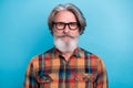 Photo of mature man good mood eyewear clever hairdo wear casual clothes isolated over blue color background Royalty Free Stock Photo