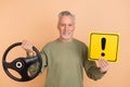 Photo of mature man hold steering-wheel sign beware road service vehicle isolated over beige color background