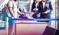 Mature man on board scanning her ticket on smartphone in airport